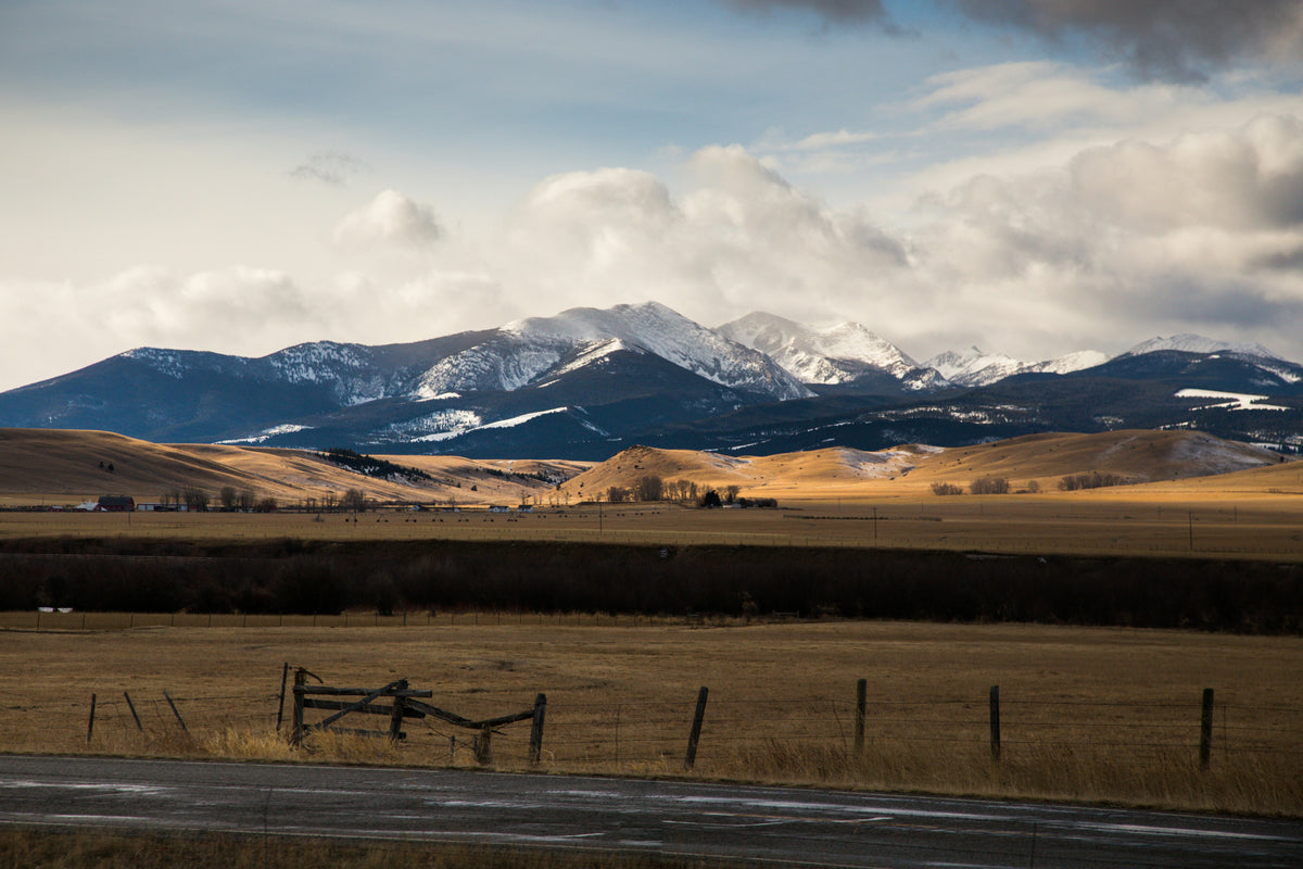 A snow-capped Montana mountain range over open fields, reflecting Rimrock Mattress Co's Billings, MT roots.
